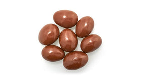 Yupik milk chocolate coated almonds with glossy finish, rich and smooth texture for snacking.