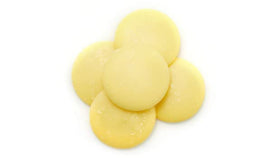 Yupik Organic Cocoa Butter Wafers arranged on a tray, ready to melt