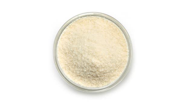 Scoop of Yupik coconut flour in a bowl highlighting fine milled texture for baking