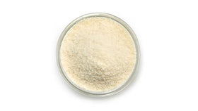 Scoop of Yupik coconut flour in a bowl highlighting fine milled texture for baking