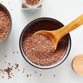 Yupik flax seeds on a spoon, convenient for snacks and recipes.