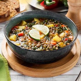 Yupik Organic Green Lentils simmering into a rich stew, earthy flavor