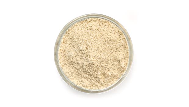 Yupik Organic Sorghum Flour being measured for gluten-free batter.