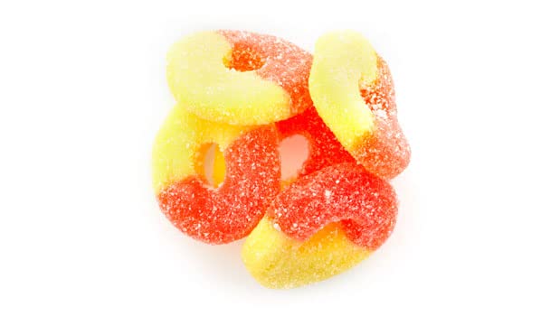 Close-up of chewy Yupik Peach Rings with a sugary coating for snacking