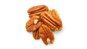 Yupik pecans halves in a white bowl, crunchy texture ready for snacking.