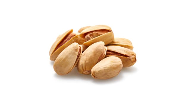 Yupik California-grown pistachios in shell on rustic backdrop evoke fresh snacking.