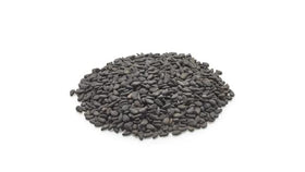 Yupik raw black sesame seeds poured over rice for nutty flavor