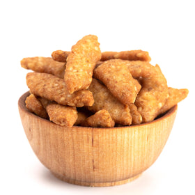 Yupik Salted Sesame Sticks on a plate, ideal for parties.