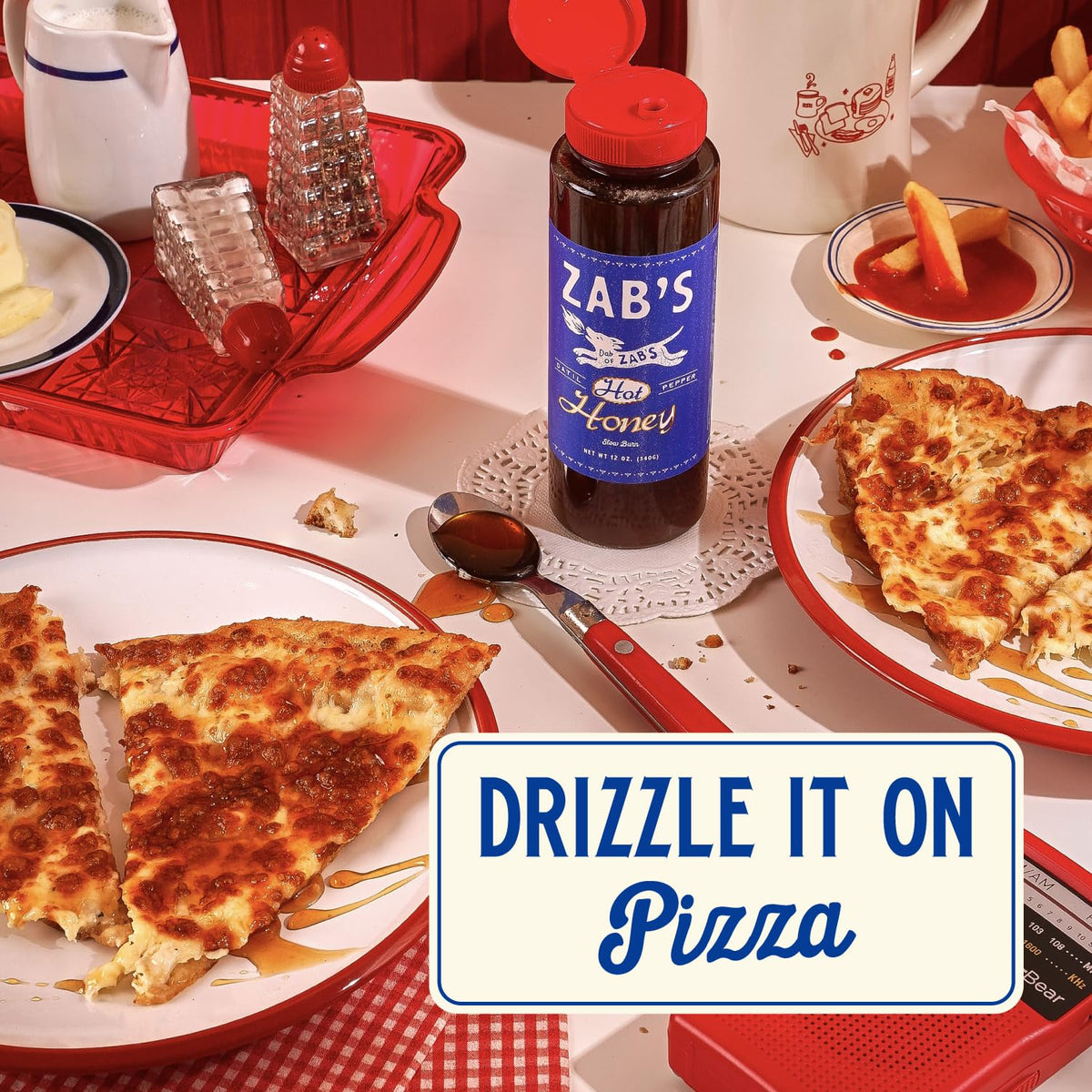 Zab's Hot Honey on a counter invites drizzle over snacks.