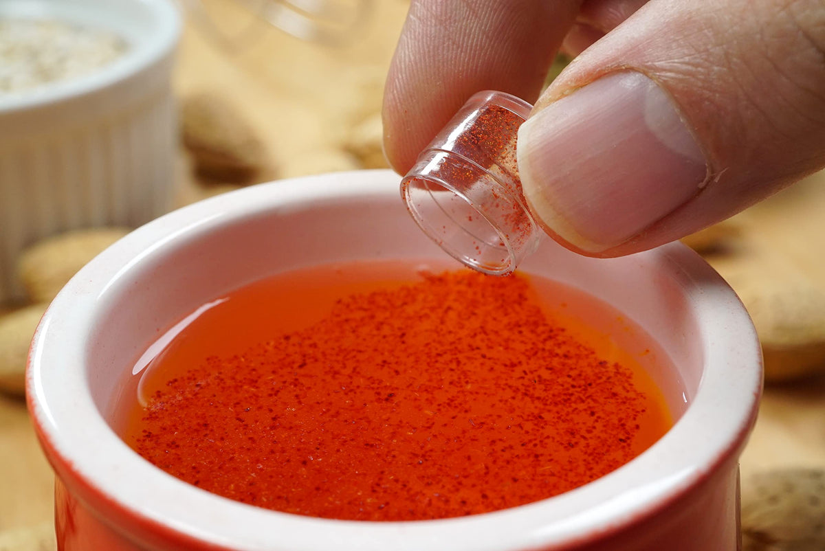 Zaffrus saffron powder over paella rice steaming for vibrant aroma.