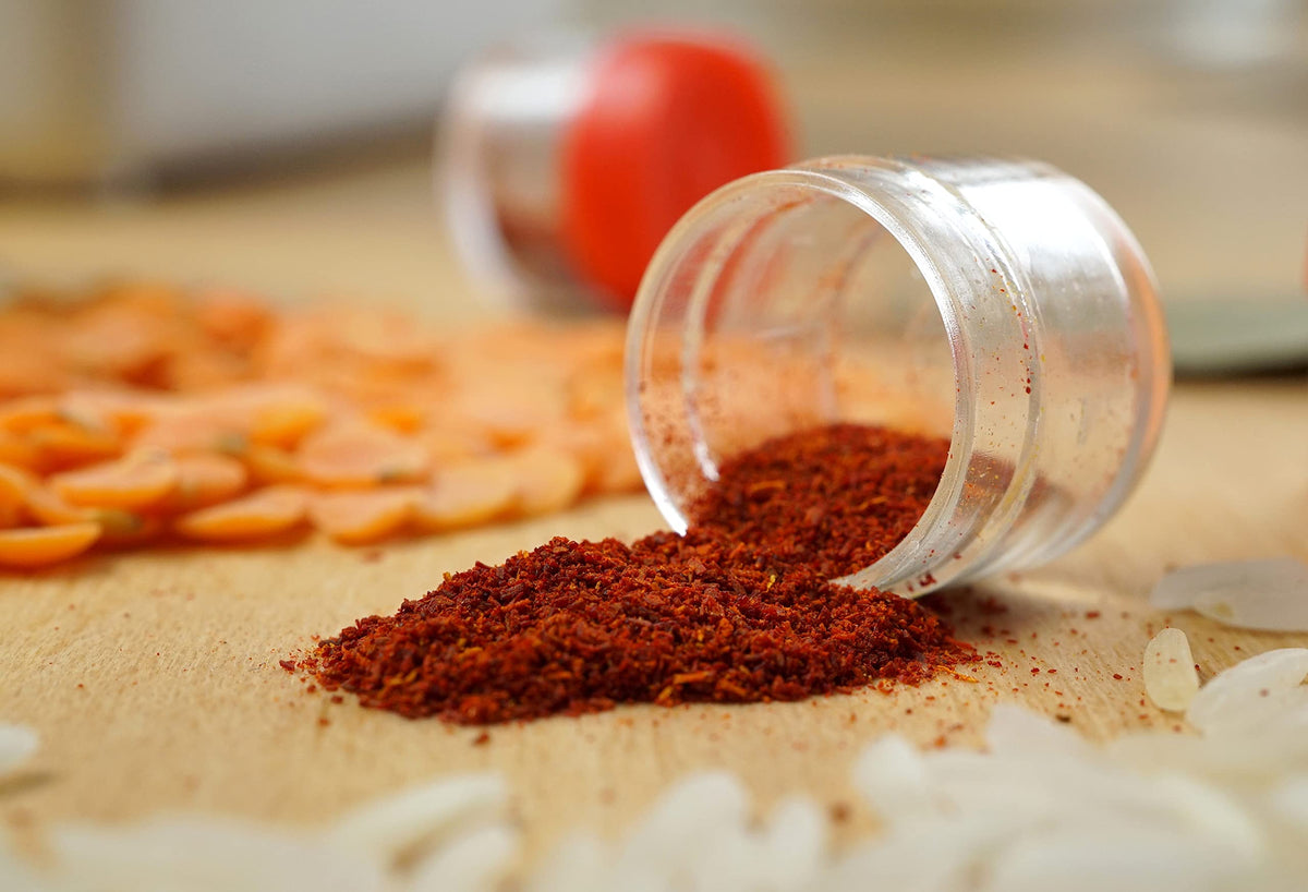 Close-up of Zaffrus saffron powder texture with spoon for easy measurement.