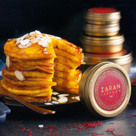 Zaran Saffron Paella dish showcases vibrant color and golden saffron threads.