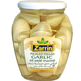 Zarrin pickled peeled garlic in a glass jar for easy flavoring in meals.
