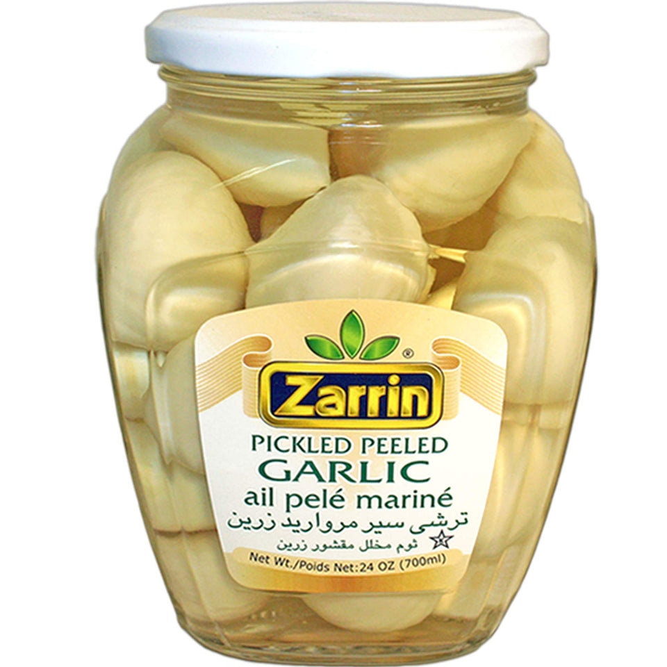 Zarrin pickled peeled garlic in a glass jar for easy flavoring in meals.
