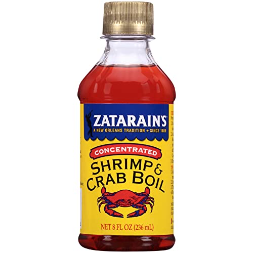 Zatarain's concentrate being poured from the bottle for quick seafood seasoning.