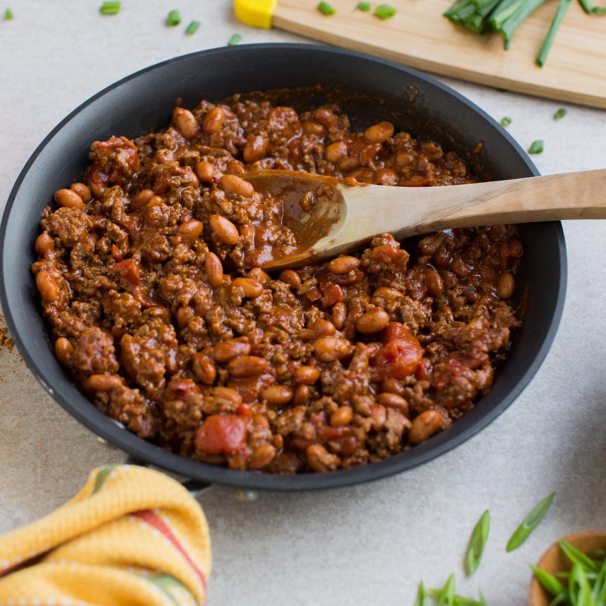 Pot simmering with beans and meat flavored by Zatarain's seasoning