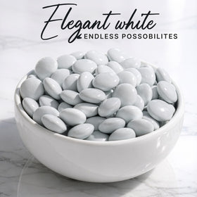Zestix candy buffet display with white shells and uniform bites for weddings.