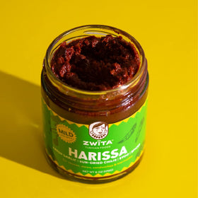 Zwita Mild Harissa bottle pouring over pasta boosts aroma and richness